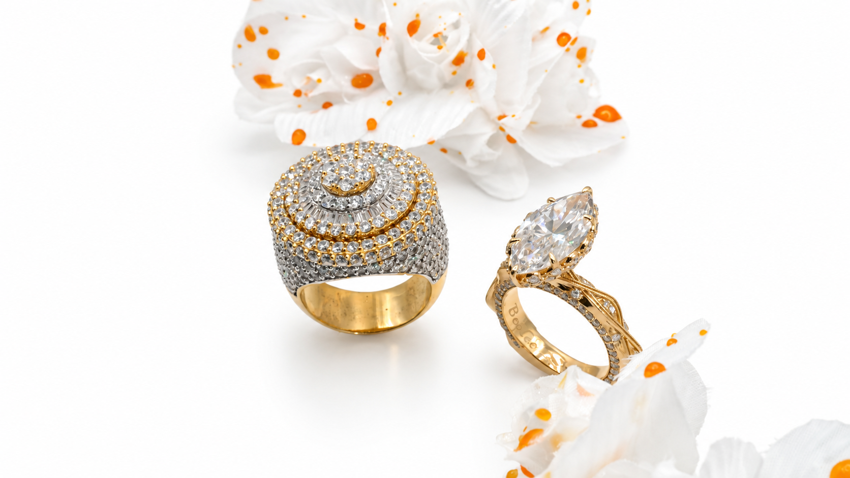 Two custom diamond rings arranged with white flowers
