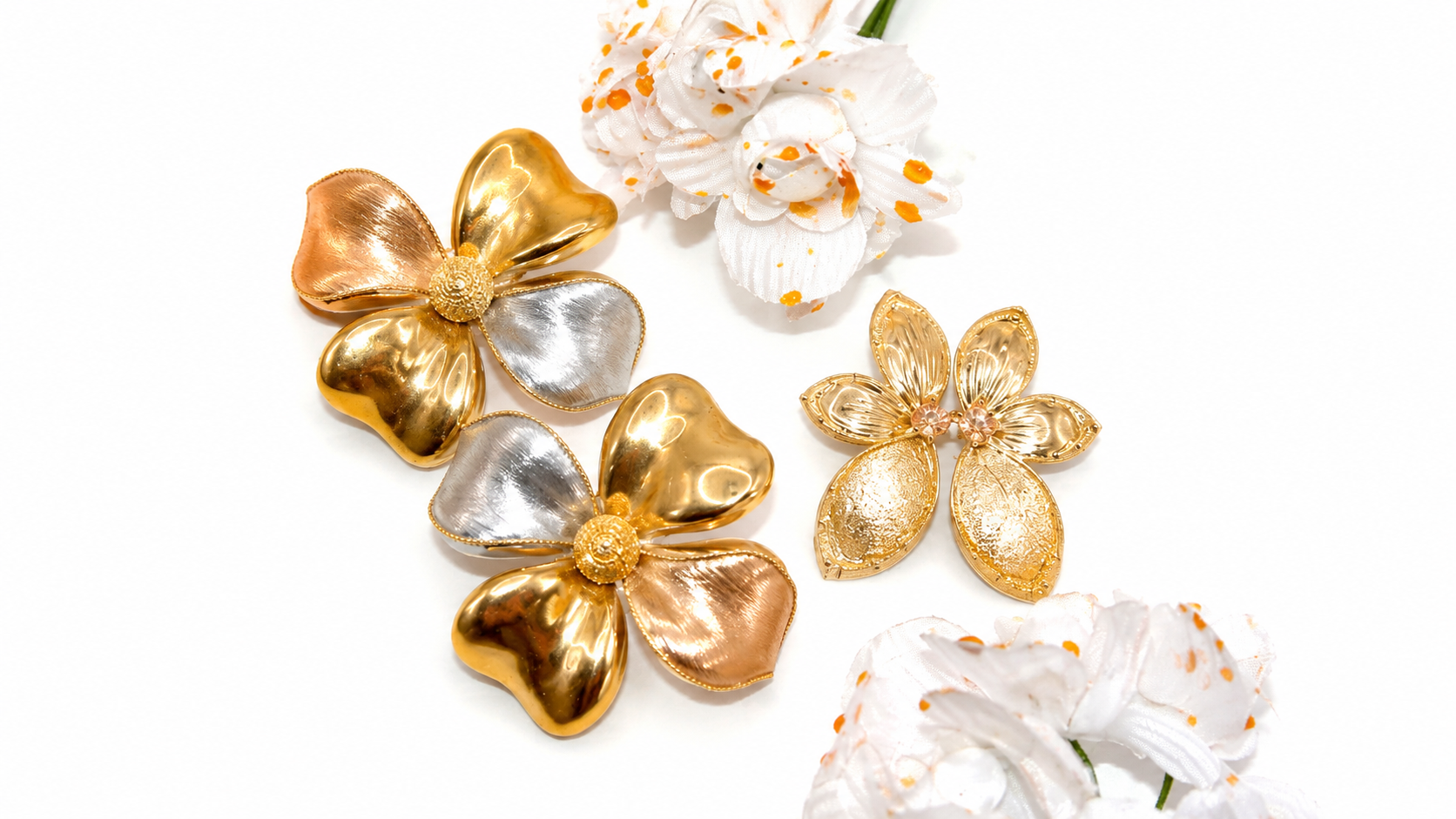 Yellow, white and rose gold floral jewellery arranged with white flowers