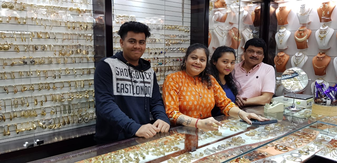 A family gathered around the jewellery counter inside Roza